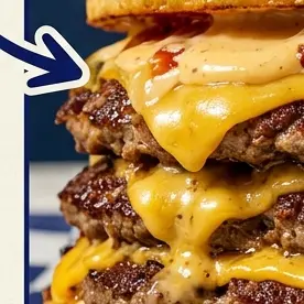 Close-up of stacked beef patties with melted cheese